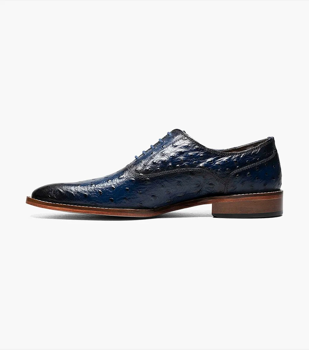 The STACY ADAMS - ROSELLI Leather Sole Plain Toe Oxford in blue, style number 25472-400, is meticulously crafted from burnished ostrich leather, featuring a rich texture that enhances its appeal. Complemented by a genuine leather sole, it offers both sophisticated style and Memory Foam comfort for all-day wear.