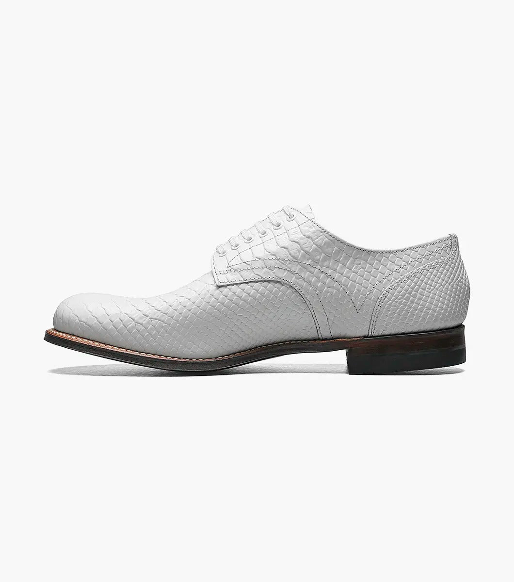 A Stacy Adams MADISON Anaconda Plain Toe Oxford in white, made with textured leather and laces, showcases a low heel and dark sole. It features Goodyear welt construction and is photographed against a white background.