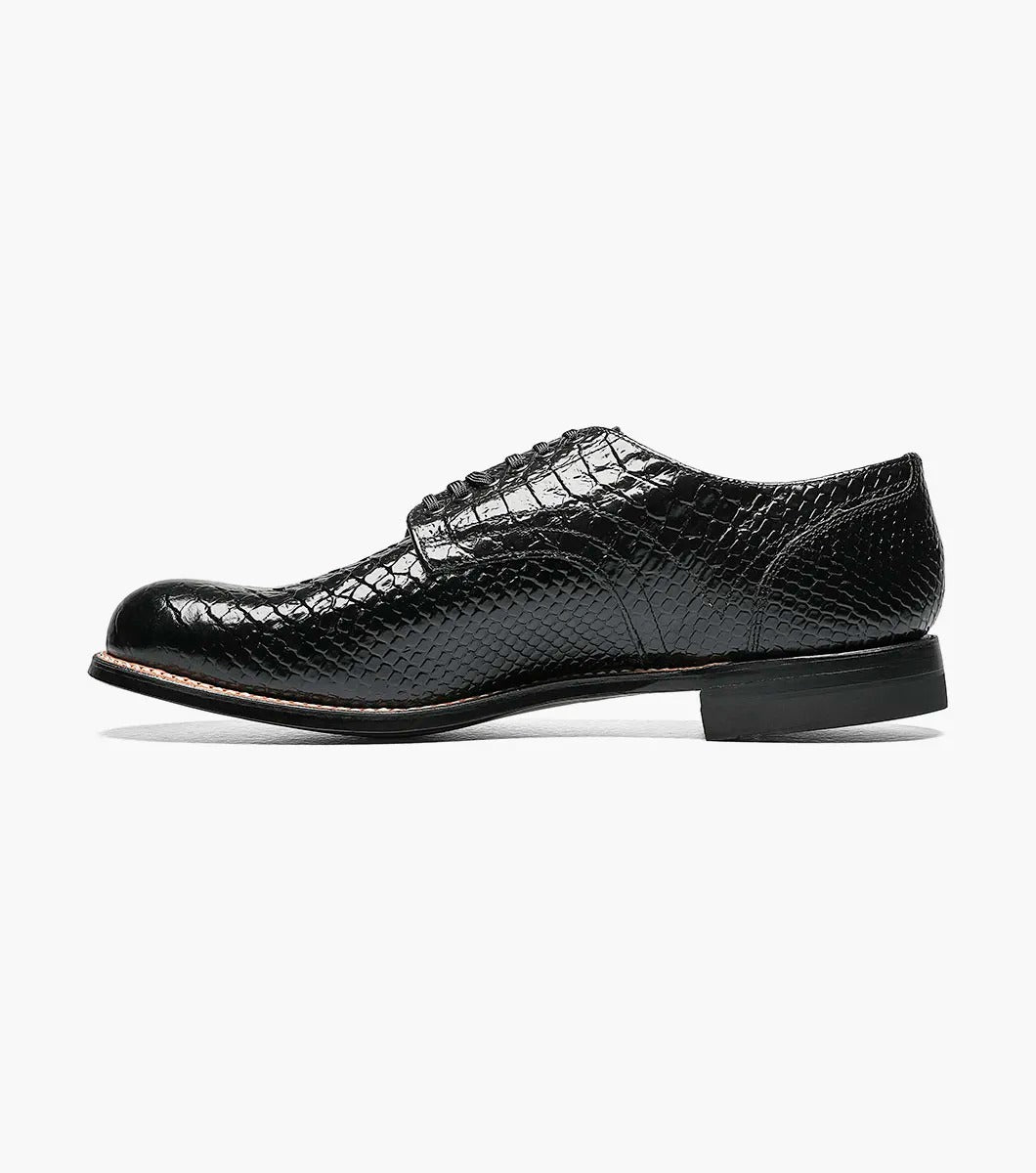 The Stacy Adams MADISON Anaconda Plain Toe Oxford in black showcases a stylish, snake-like pattern with its elegant anaconda print, complemented by a low heel, all displayed on a plain white background.