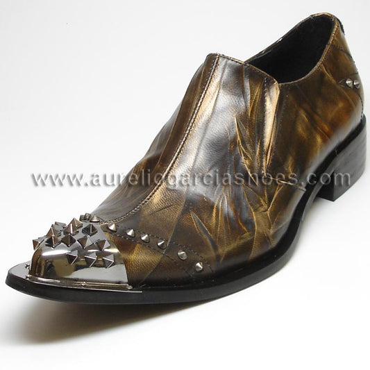 Introducing the FI-6844 Brown Fiesso by Aurelio Garcia, a cutting-edge leather shoe from the Fiesso brand, featuring a metallic pointed toe embellished with spikes and studs. This design incorporates a cushioned insole and low heel for optimal comfort, all within a sophisticated silhouette.