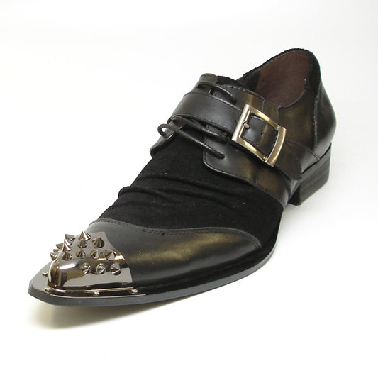 The FI-6861 Black Fiesso By Aurelio Garcia, crafted by Fiesso, showcases a sophisticated black leather upper adorned with striking metal spikes on the toe and a chic buckle strap across the top. Designed with a cushioned insole for enhanced comfort, this shoe combines bold style with wearability for any daring occasion.