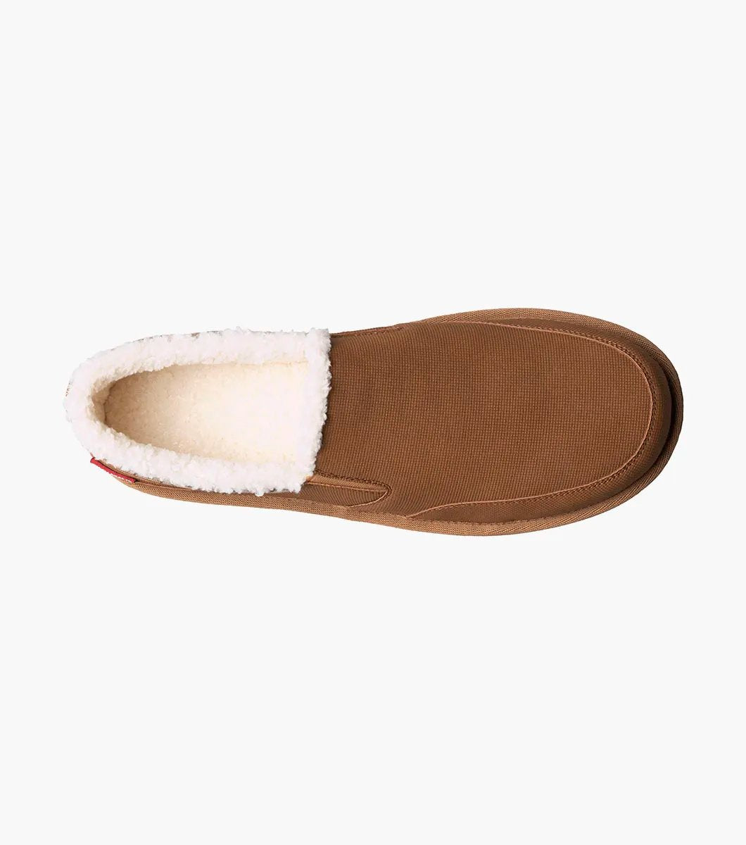 The Stacy Adams - COZE Moc Toe Slip On - Tan Multi - 25558-238, from STACY ADAMS, boasts a textured fabric exterior and soft faux shearling lining. It features a cushioned insole and a brown rubber sole.