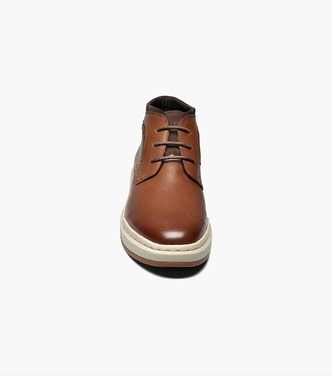 Stacy Adams' CORBIN Plain Toe Chukka Boot features a cognac smooth finish with decorative perforations, a comfortable insole, white sole, and brown laces displayed on a plain white background.