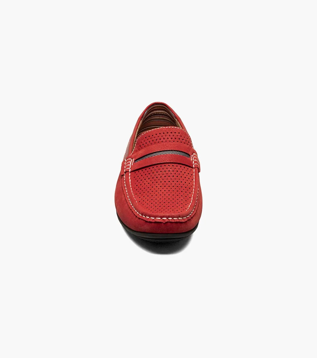 Introducing the Stacy Adams - CORBY Moc Toe Saddle Slip On in Red (25513-600). This shoe features a red leather loafer design with a perforated upper, complemented by black and red stripe detailing on top. It also boasts a durable rubber outsole, making it the ideal casual warm-weather shoe with its stylish appearance and comfortable fit from STACY ADAMS.