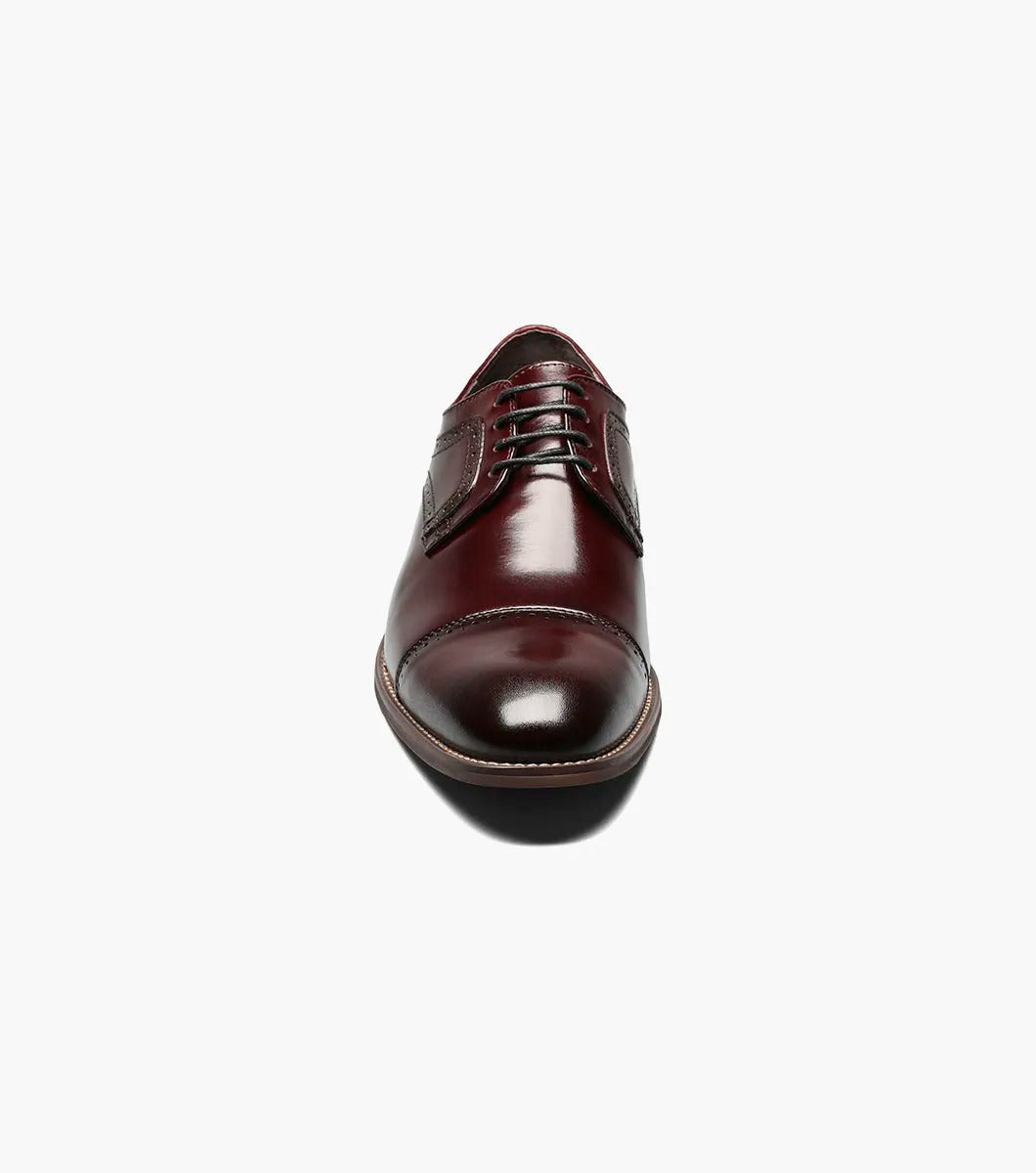 The Stacy Adams DICKINSON Cap Toe Oxford in Burgundy, style number 25066-601, is a classic leather dress shoe from STACY ADAMS. It features laces and decorative stitching and is enhanced with memory foam for ultimate comfort, set against a white background.