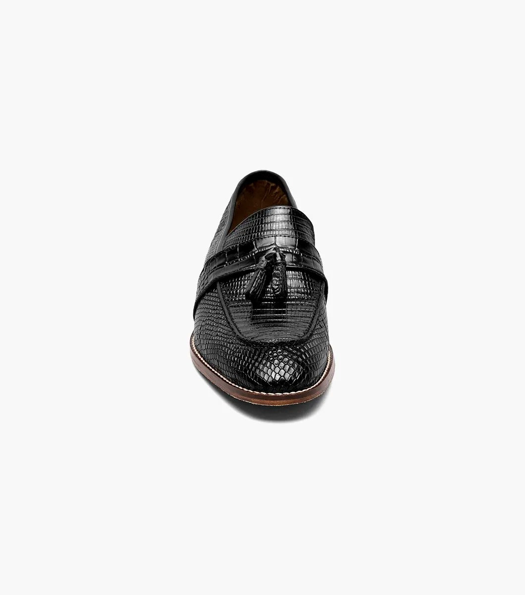 From the Stacy Adams PACETTI collection, this black leather Moc Toe Tassel Slip On loafer features a textured finish, memory foam insole, and brown sole against a white background.