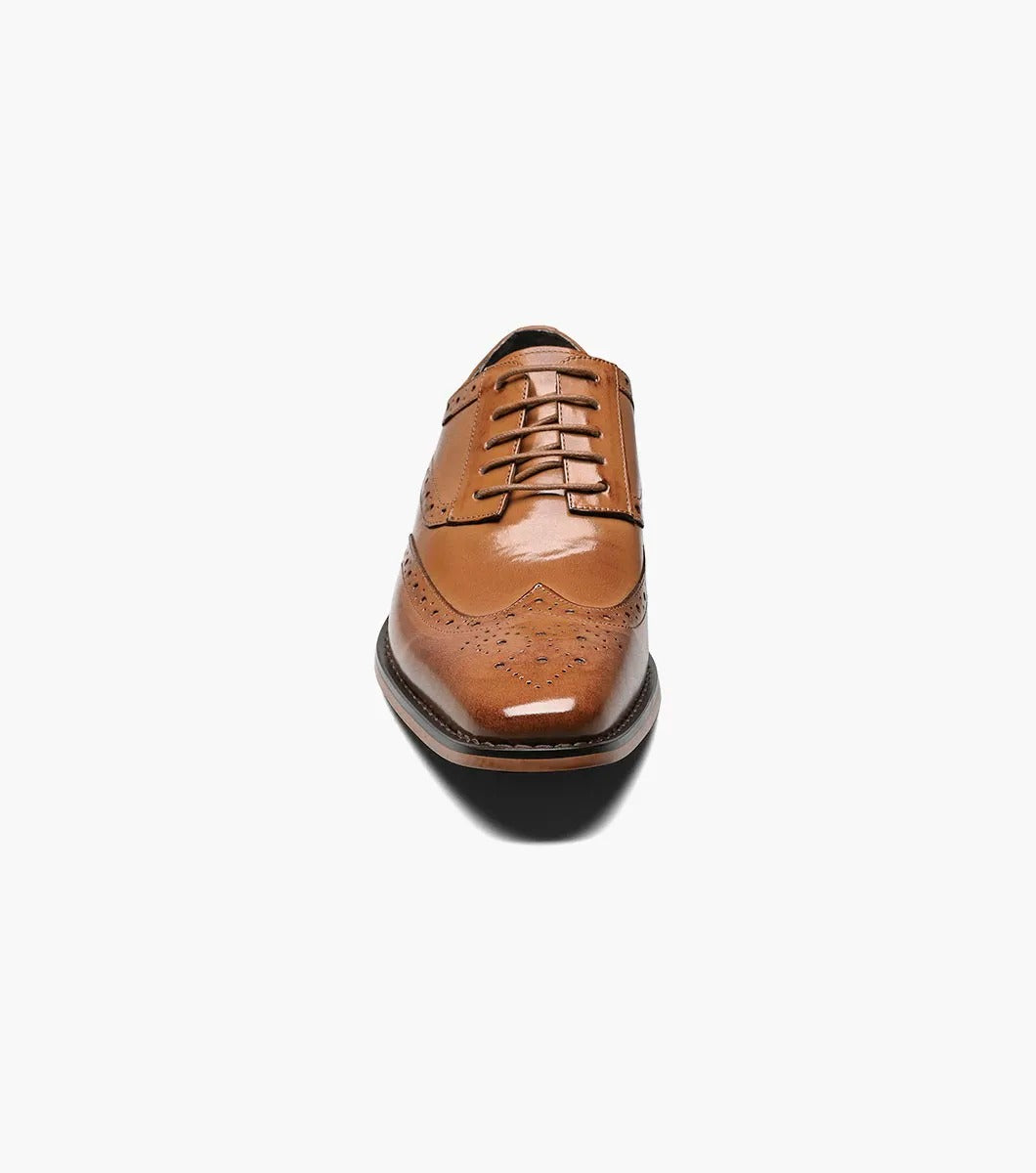 Stacy Adams TINSLEY Wingtip Oxford in tan, featuring decorative perforations, lace-up closure, and a low heel, displayed on a white background.