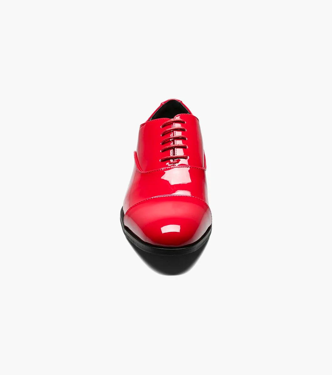 A solitary Stacy Adams GALA Cap Toe Oxford, product number 24998-600, made of shiny red patent leather with black soles and a closed lacing system featuring a memory foam insole, is displayed against a plain white background.