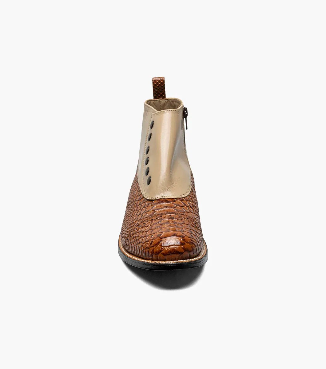 The Stacy Adams MADISON Spectator Spat Cap Toe Demi Boot in Tan Multi showcases a sophisticated design with a smooth kidskin leather upper, textured lower, and black side buttons, complemented by a genuine leather sole for timeless elegance.