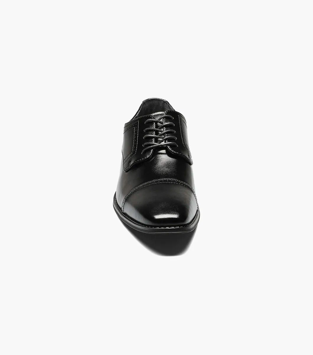 The Stacy Adams WALTHAM Cap Toe Oxford in black (model 20138-001) is a stylish leather dress shoe featuring laces, a sleek cap toe design, and elegant decorative stitching. The low heel and dress style rubber sole ensure modern comfort while maintaining timeless sophistication.