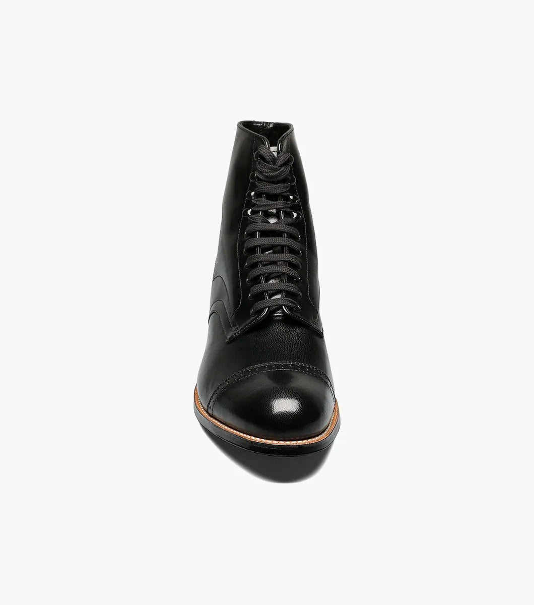 The Stacy Adams MADISON Cap Toe Boot in black, model 00015-01, features a refined design with a polished finish and cap toe. Constructed using Goodyear welt technology, it offers lasting durability and classic style.