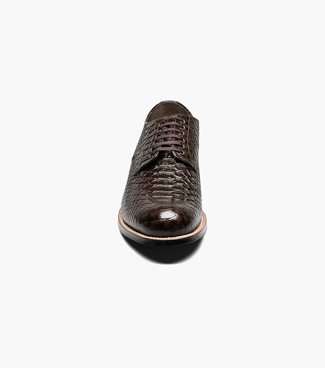 The Stacy Adams MADISON Anaconda Plain Toe Oxford in brown showcases an anaconda print with black laces, set against a white background.