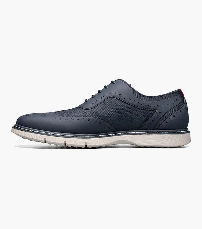 A single Stacy Adams - SUMMIT Wingtip Lace Up shoe in navy, featuring perforated leather with a white sole and wingtip design, viewed from the front.