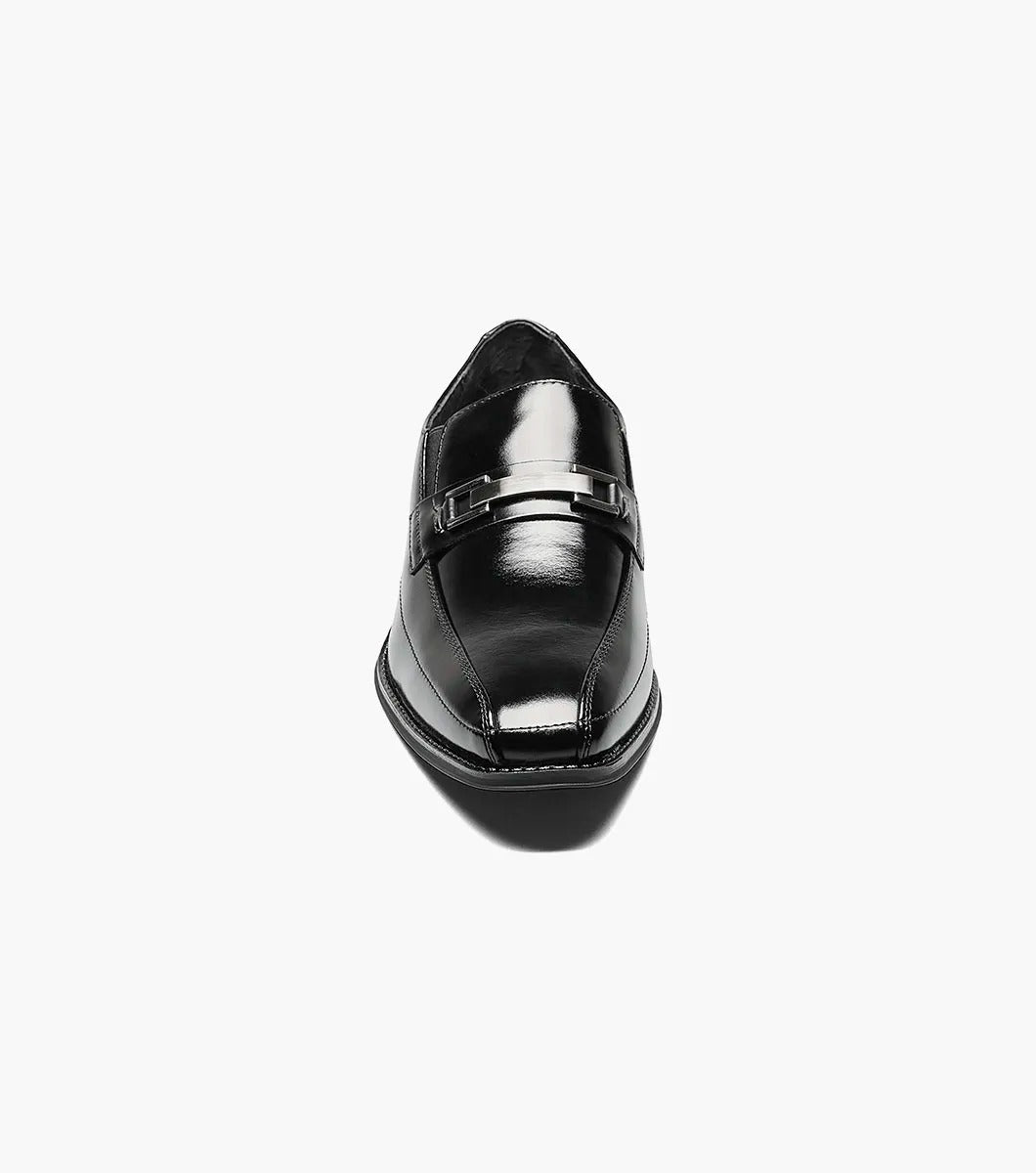 The Stacy Adams WAKEFIELD Bike Toe Bit Slip On in black is a sleekly designed leather men's dress shoe with a metallic decorative strap across the top and a cushioned footbed for added comfort. This perfectly crafted slip-on style offers easy wear.