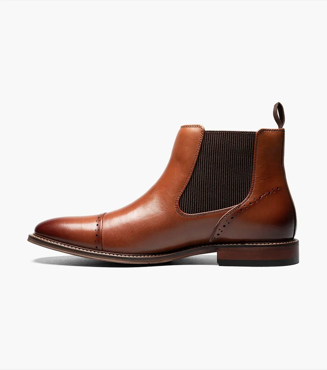 The Stacy Adams MAURY Cap Toe Chelsea Boot in Cognac features ergonomic elastic side panels, anatomical arch support, and a convenient pull tab on the heel.