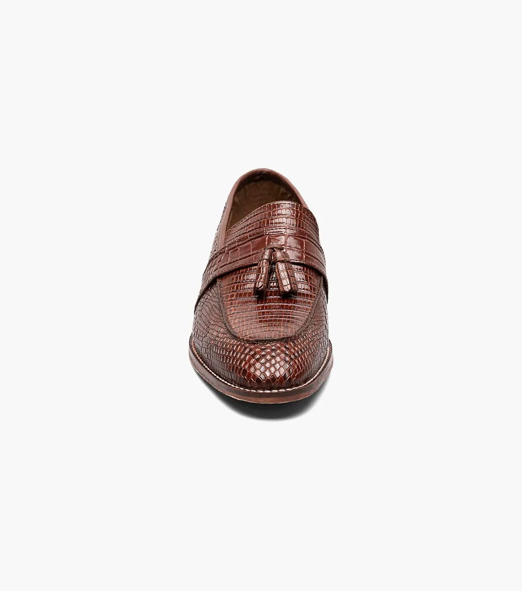 The Stacy Adams - PACETTI Leather Sole Moc Toe Tassel Slip On in Cognac, featuring a textured pattern with tassels on the front and a comfortable memory foam insole, is displayed against a plain white background.