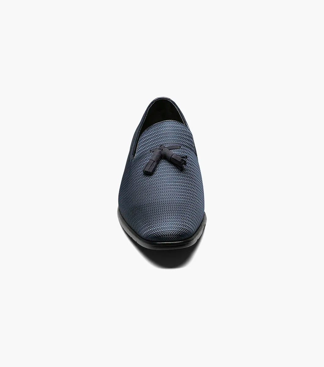 Here's a revised version of the sentence using the provided product data:

A single navy Stacy Adams TAZEWELL Plain Toe Tassel Slip-On loafer, identified by its tassel detail and textured finish, viewed from the side. This loafer features a low heel, sleek design, and cushioned footbed for added comfort.