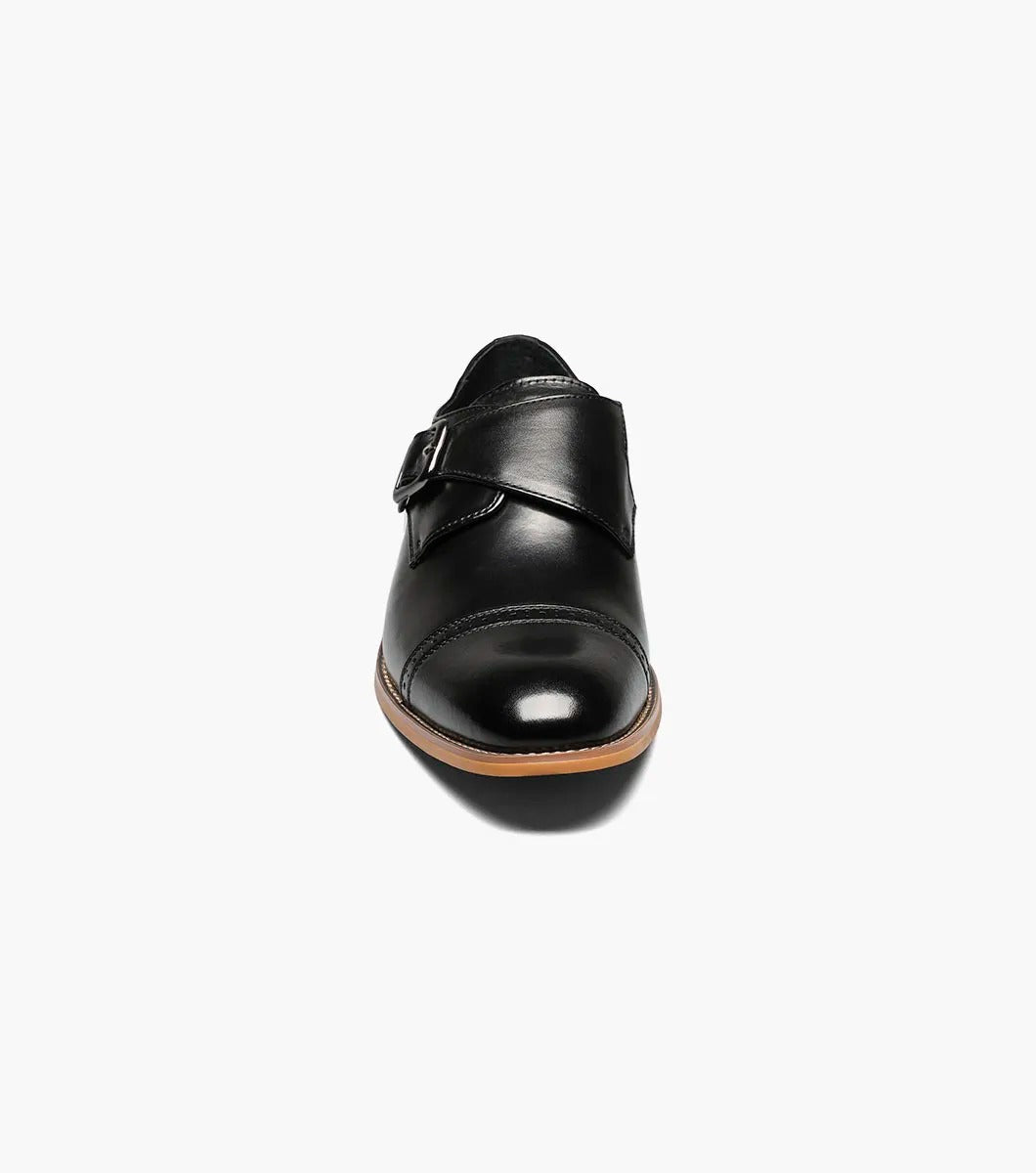 The Stacy Adams - DESMOND Cap Toe Monk Strap in Black, model number 25162-001, showcases a sophisticated black leather design with a cap toe and buckle strap, enhanced by a brown sole and a comfortable memory foam insole.