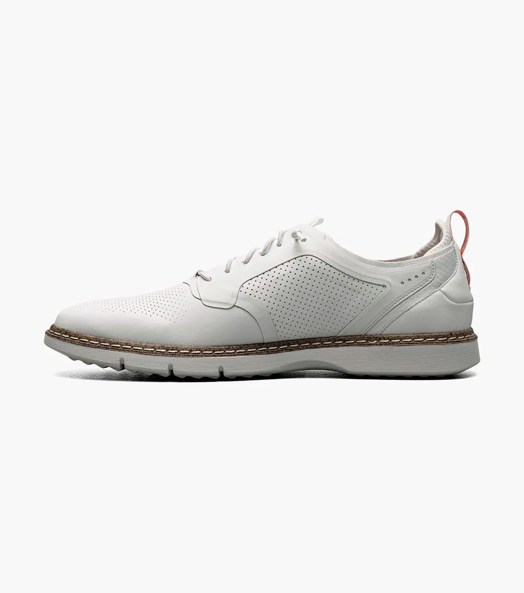 The Stacy Adams SYNCHRO Plain Toe Elastic Lace Up - White - 25518-100 is a versatile shoe showcasing white perforated leather with elastic laces, a brown sole, and a red pull tab at the heel. Crafted by STACY ADAMS for comfort, it offers anatomical arch support, making it ideal for any occasion.