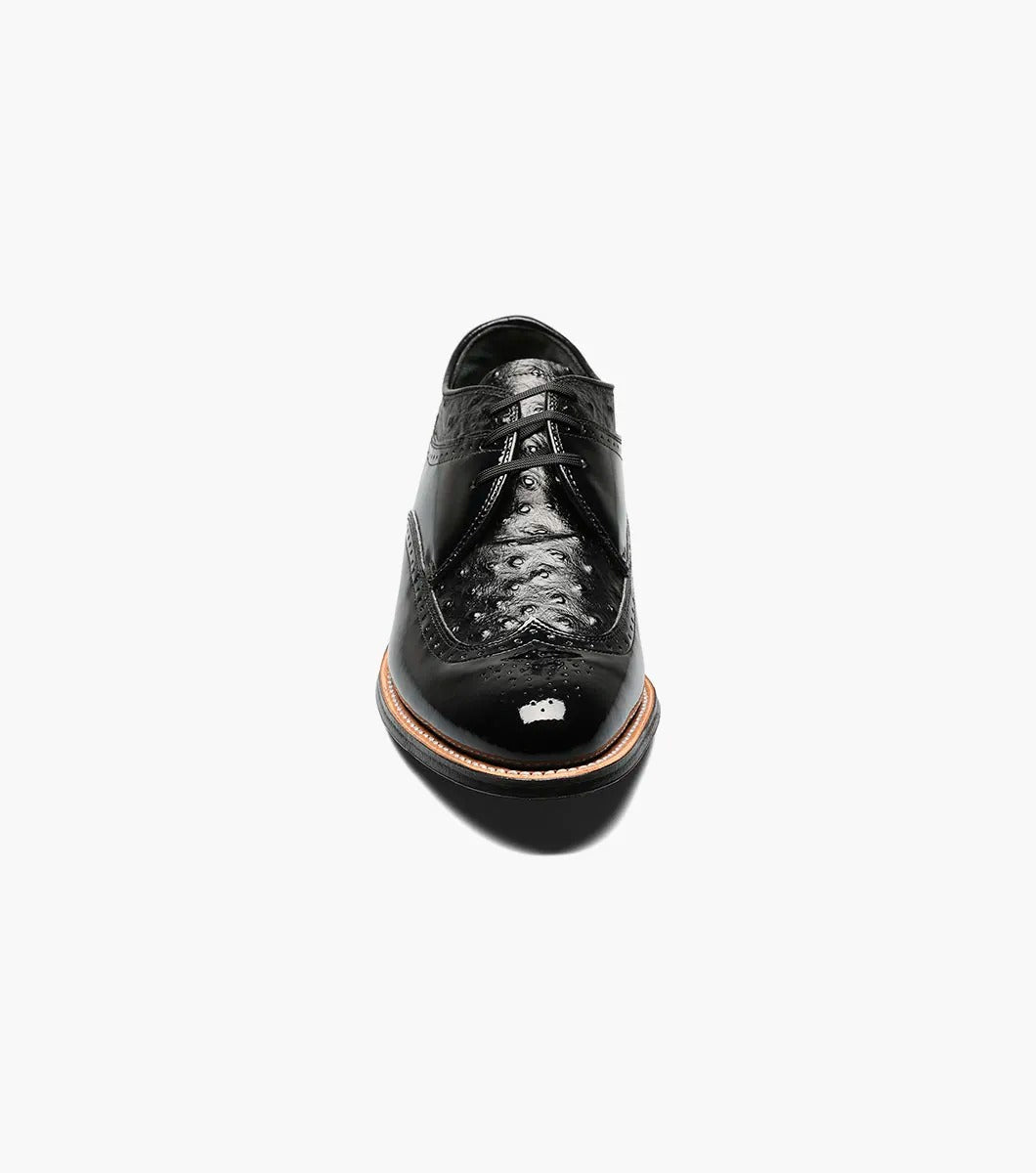 The Stacy Adams - DAYTON Ostrich Wingtip Oxford in black, style number 00375-01, is a single leather dress shoe with decorative perforations and a polished finish. It features laces and a slight heel.