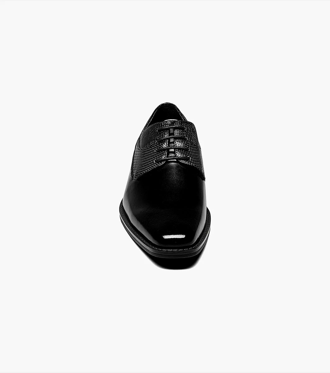 A single Stacy Adams Kirkley Plain Toe Oxford shoe in black, featuring a shiny finish and textured leather detailing on the sides.