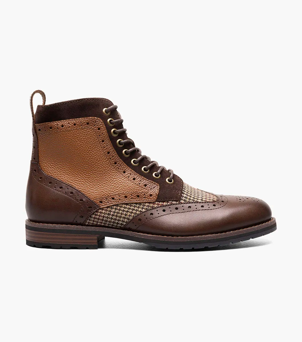 Introducing the Stacy Adams OSWYN Wingtip Lace Up Boot in Brown Multi. This stylish boot from STACY ADAMS features a combination of brown leather and tweed with intricate perforations, a mixed material upper, and a textured sole for unmatched comfort. Enhanced with a Memory Foam insole, these lace-ups provide superior cushioning and support for all-day wear. Product code: 25552-249.