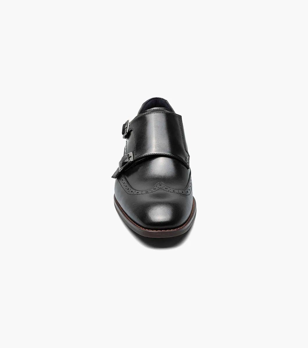 The Stacy Adams KARSON Wingtip Double Monk Strap - Black (model 25570-001) showcases a sophisticated black leather dress shoe with brogue detailing, set against a white background, crafted from premium leather.