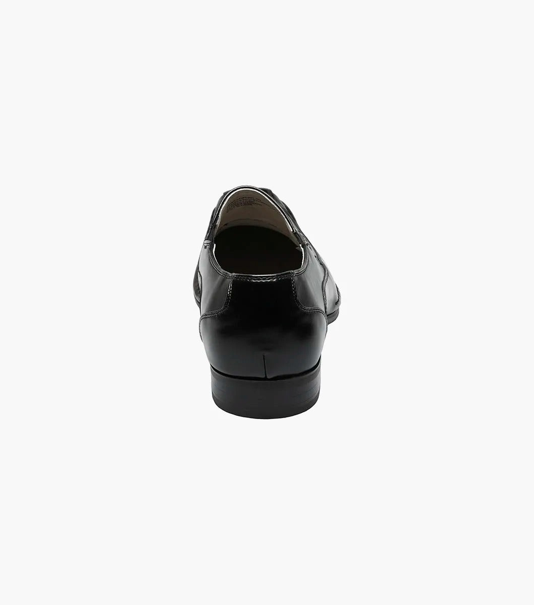 The Stacy Adams - TEMPLIN Bike Toe Loafer in black, designed by STACY ADAMS and identified with model number 24507-001, is a genuine leather shoe boasting a shiny finish and subtle stitching details. It features a cushioned insole for ultimate comfort and is showcased on a plain white background.