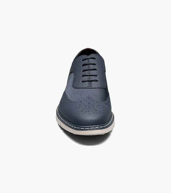 A single Stacy Adams - SUMMIT Wingtip Lace Up shoe in navy, featuring perforated leather with a white sole and wingtip design, viewed from the front.