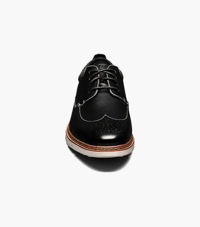 Stacy Adams' SYNERGY Wingtip Oxford in black (25418-001) showcases decorative perforations and a lace-up design, complemented by a contrasting light brown sole and featuring the RedZone footbed for enhanced comfort.