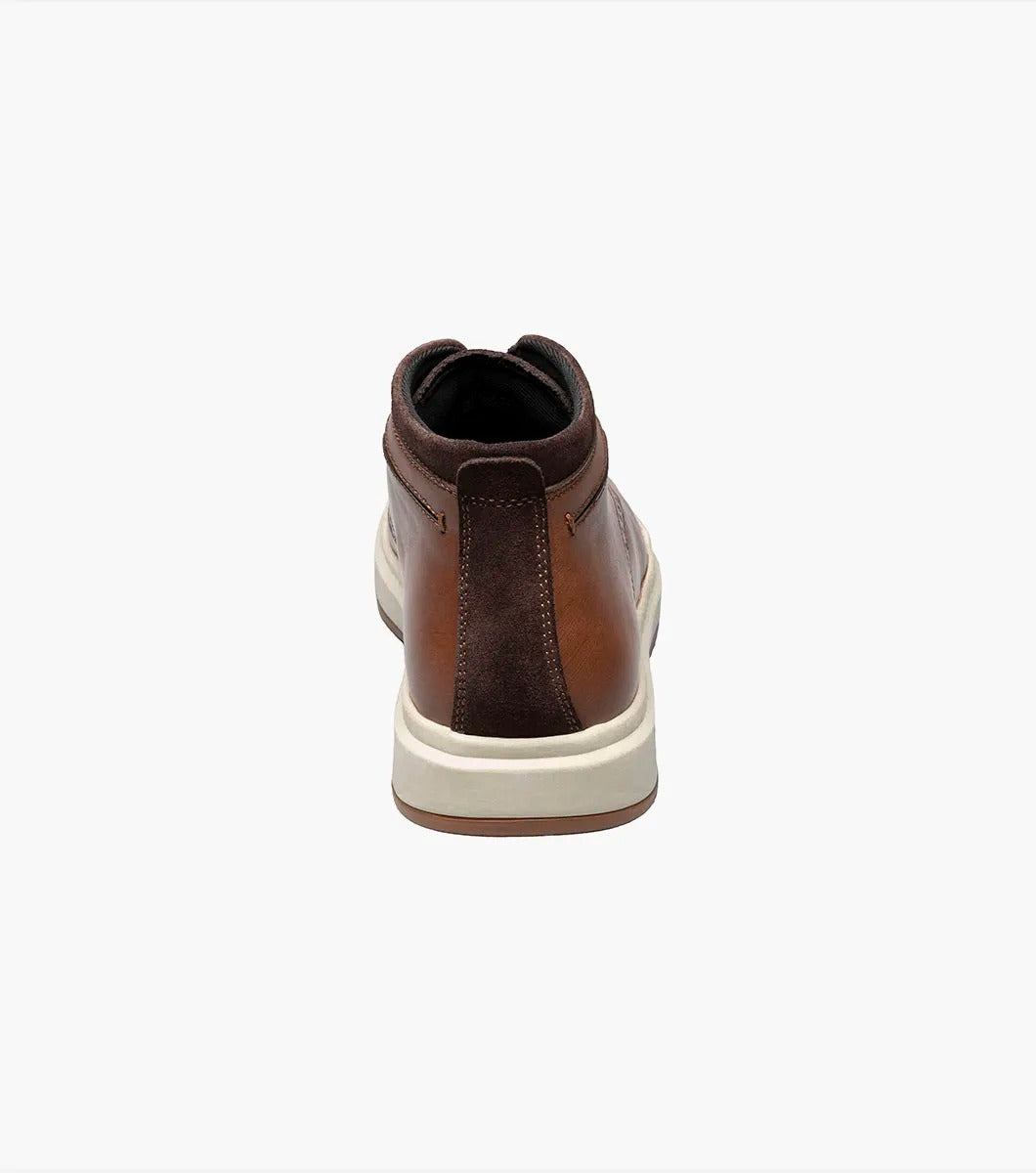 Stacy Adams' CORBIN Plain Toe Chukka Boot features a cognac smooth finish with decorative perforations, a comfortable insole, white sole, and brown laces displayed on a plain white background.