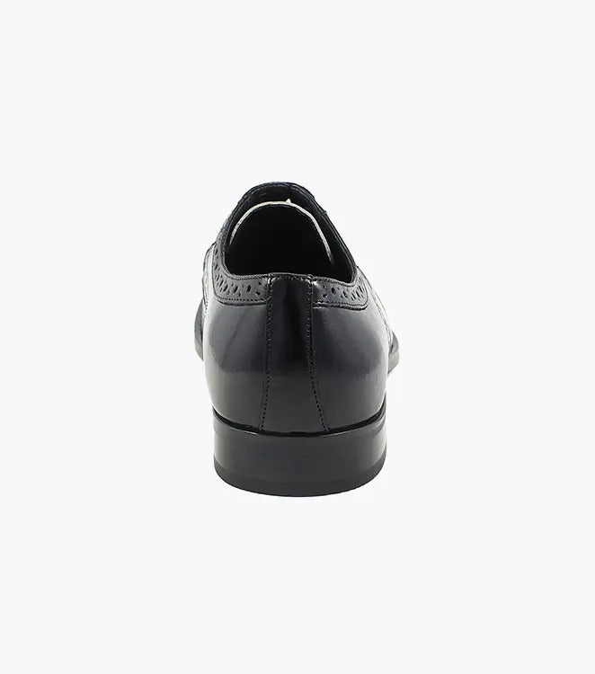 The Stacy Adams TINSLEY Wingtip Oxford in black with white, product number 25092-111, is a stylish shoe crafted from buffalo leather featuring decorative perforations and black laces.