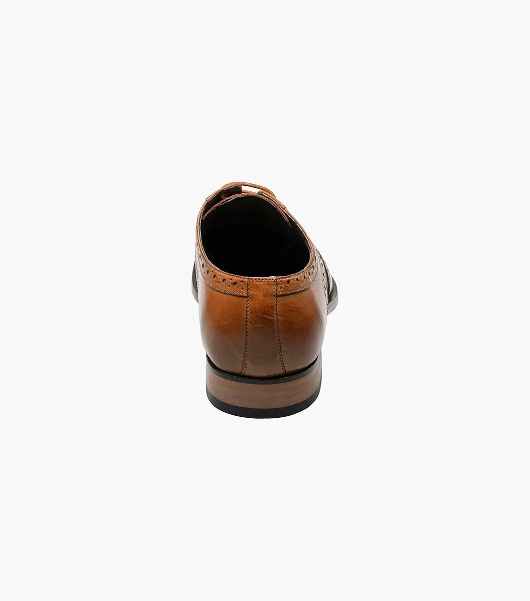 Stacy Adams TINSLEY Wingtip Oxford in tan, featuring decorative perforations, lace-up closure, and a low heel, displayed on a white background.