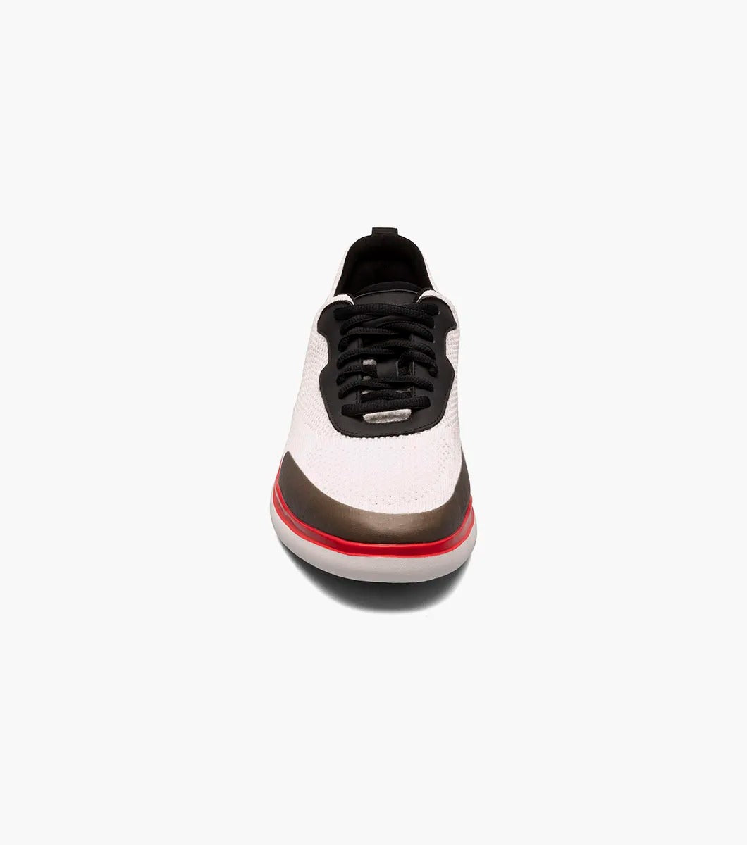 The Stacy Adams - MAXSON Moc Toe Lace Up Sneaker in White Multi (style 25517-110) showcases a sleek design with black accents, a striking red sole, and a distinctive brown toe cap. This hybrid sneaker-casual shoe provides both versatility and comfort, enhanced by the RedZone removable footbed for premium support.