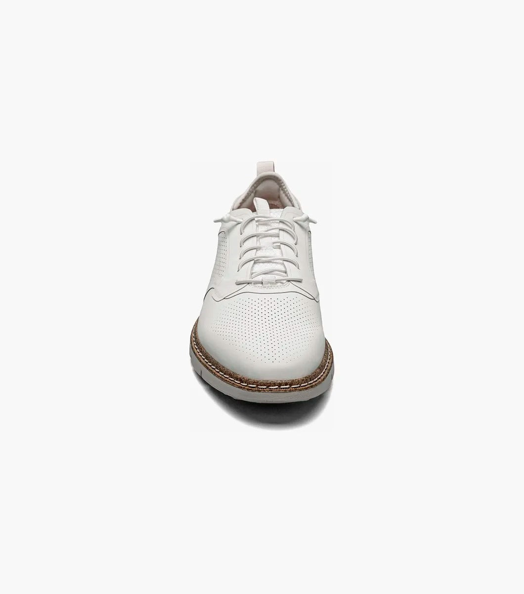 The Stacy Adams SYNCHRO Plain Toe Elastic Lace Up - White - 25518-100 is a versatile shoe showcasing white perforated leather with elastic laces, a brown sole, and a red pull tab at the heel. Crafted by STACY ADAMS for comfort, it offers anatomical arch support, making it ideal for any occasion.