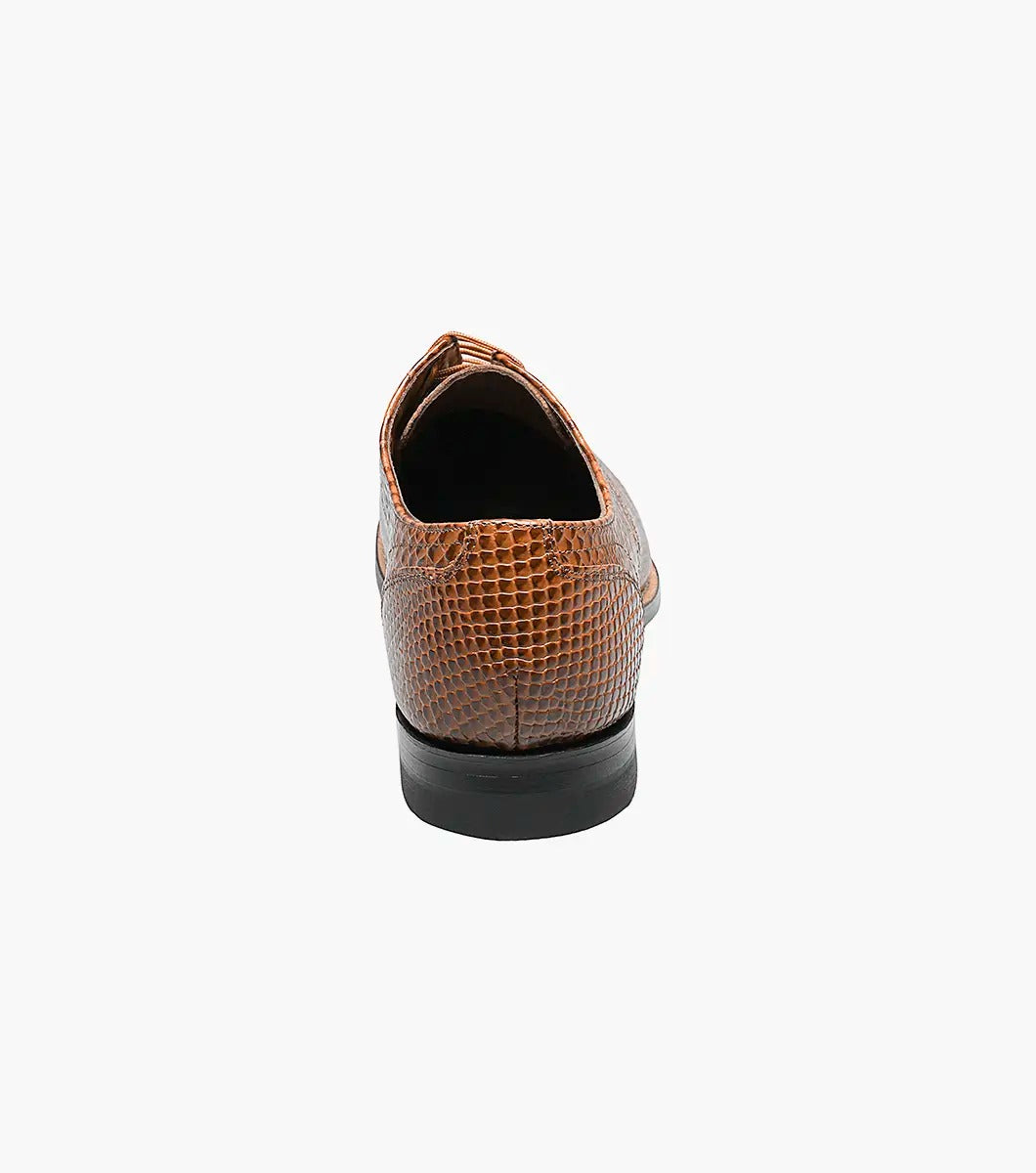 The Stacy Adams - MADISON Anaconda Plain Toe Oxford in tan showcases a lace-up design with a textured anaconda print on brown leather, genuine welt construction, and is complemented by a black sole.