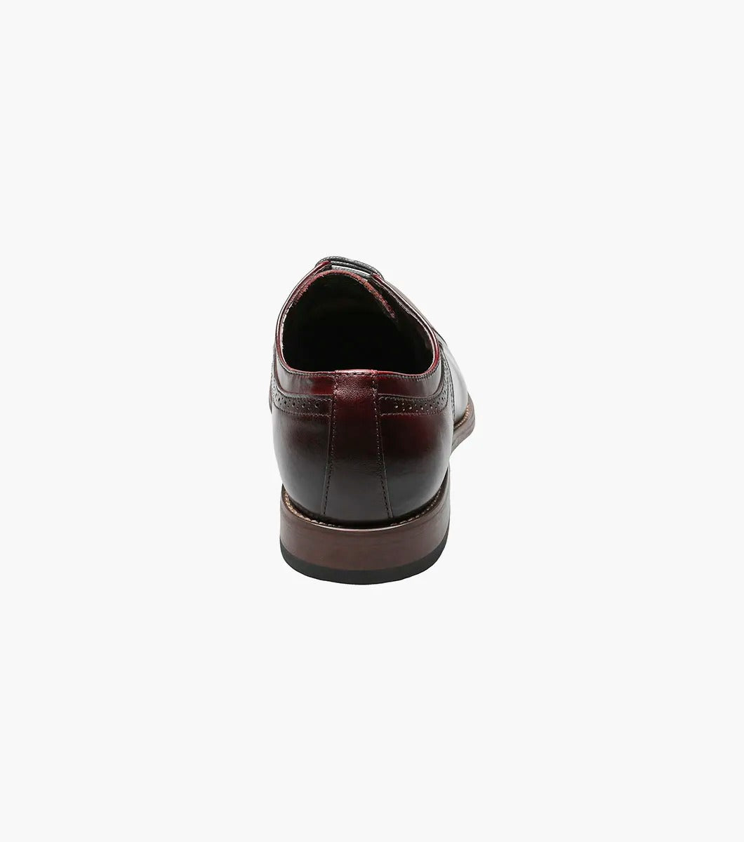 The Stacy Adams DICKINSON Cap Toe Oxford in Burgundy, style number 25066-601, is a classic leather dress shoe from STACY ADAMS. It features laces and decorative stitching and is enhanced with memory foam for ultimate comfort, set against a white background.