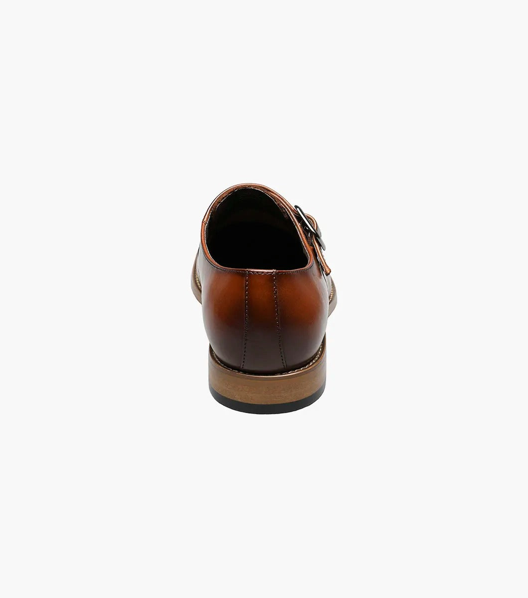 The Stacy Adams DESMOND Cap Toe Monk Strap in cognac combines a buckle, decorative perforations, cap toe detailing, and a wooden heel for a sophisticated look.