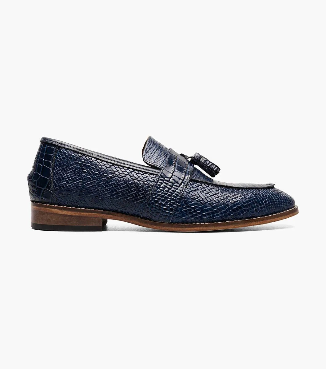 The Stacy Adams PACETTI Leather Sole Moc Toe Tassel Slip On in blue features a textured design with a memory foam insole and a brown sole.