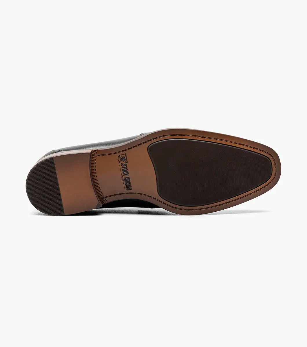 The Stacy Adams KAYLOR Moc Toe Bit Slip On in black (model 25572-001) is a sophisticated leather loafer from STACY ADAMS, highlighted by a sleek metal buckle, wooden heel, and premium leather upper. Perfectly set against a white background, it features the supportive RedZone footbed for exceptional comfort.