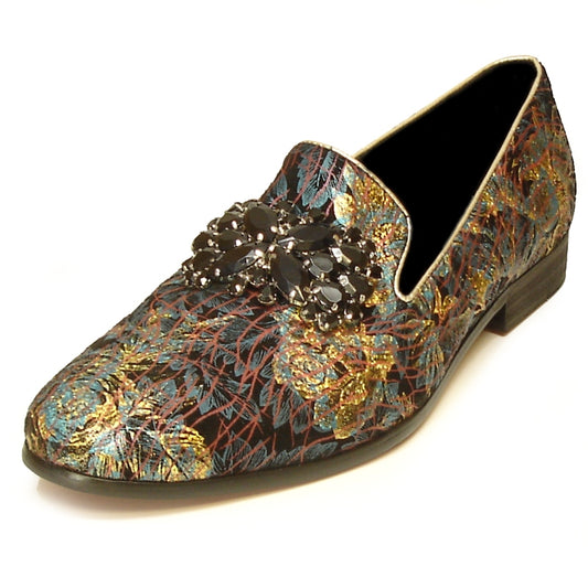 The FI-7029 Blue Gold Fiesso by Aurelio Garcia is a chic loafer from the Fiesso brand, showcasing a vibrant floral pattern on its brocade design with a luxurious leather upper. It features an elegant black embellishment on top and is finished with a cushioned insole for enhanced comfort.