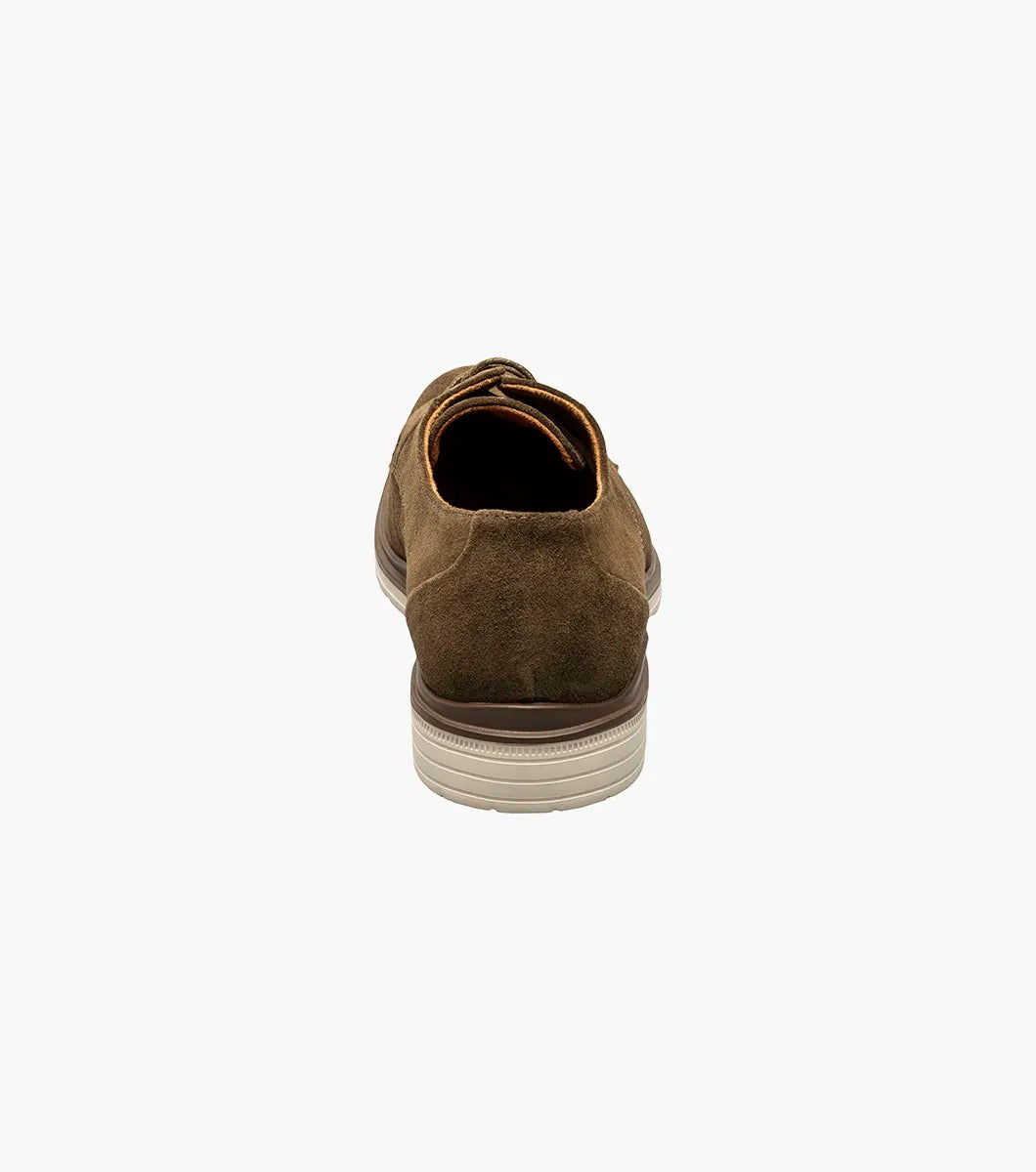 Product: STACY ADAMS presents the TAYSON Plain Toe Lace Up, model 25522-245, featuring a brown suede exterior with a light beige sole and anatomical arch support. This shoe offers a round toe design and laced closure for added comfort and style.