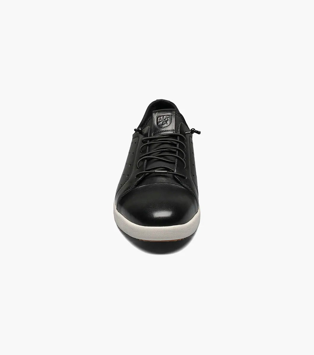 The Stacy Adams - HALDEN Lace Up Sneaker in black showcases a burnished leather upper and perforated side details, set against a plain white backdrop. It features a white rubber sole and cushioned footbed for optimal comfort.