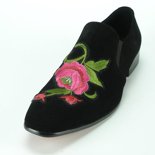 The FI-7085 Black Fiesso by Aurelio Garcia, from the brand Fiesso, is a stylish fashion shoe featuring a leather upper with pink and green floral embroidery. It has a low heel, cushioned insole, and pointed toe.