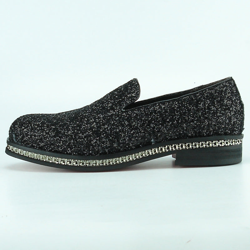 The FI-7118 Black Fiesso by Aurelio Garcia shoes from the Fiesso brand showcase a textured black and gray leather slip-on design, complete with a chunky sole and decorative trim. Ideal for fashion-forward individuals who value comfort without sacrificing style.