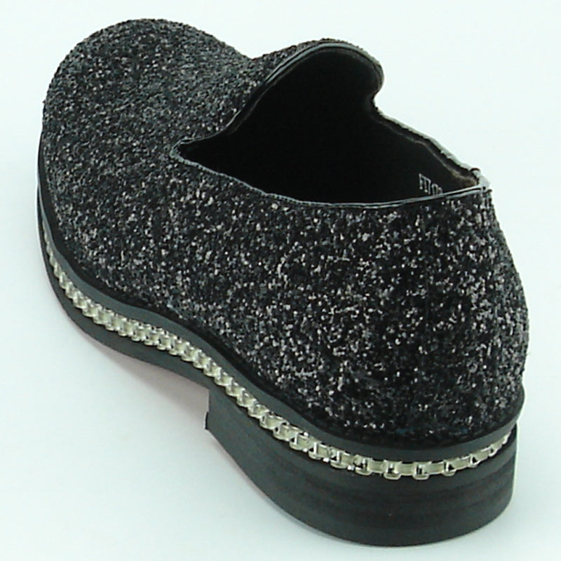 The FI-7118 Black Fiesso by Aurelio Garcia shoes from the Fiesso brand showcase a textured black and gray leather slip-on design, complete with a chunky sole and decorative trim. Ideal for fashion-forward individuals who value comfort without sacrificing style.