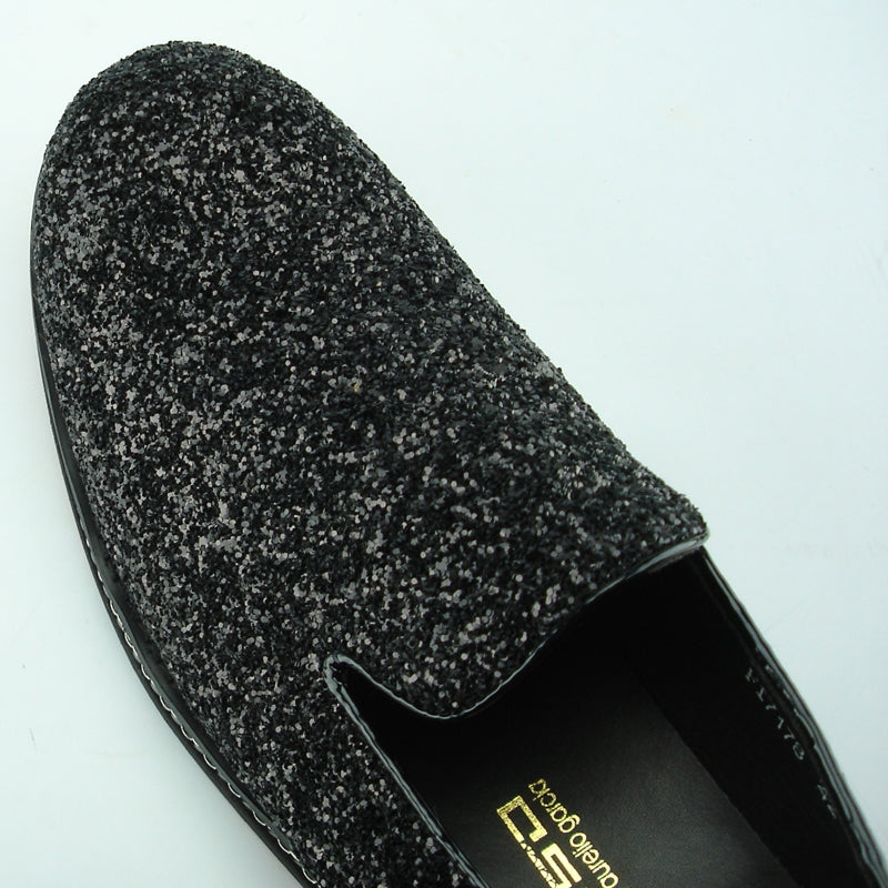 The FI-7118 Black Fiesso by Aurelio Garcia shoes from the Fiesso brand showcase a textured black and gray leather slip-on design, complete with a chunky sole and decorative trim. Ideal for fashion-forward individuals who value comfort without sacrificing style.