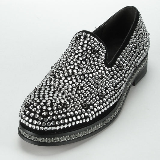 The FI-7119 Black Fiesso by Aurelio Garcia, from the Fiesso brand, is a slip-on fashion shoe featuring a leather upper embellished with silver studs and rhinestones, displayed gracefully against a white backdrop. Its cushioned insole guarantees both comfort and style.