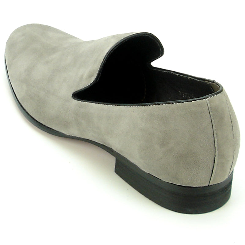 The FI-7216 slip-on loafer from Fiesso showcases a sophisticated grey suede upper by Aurelio Garcia, complemented by a sleek black sole and presented on a pristine white background.