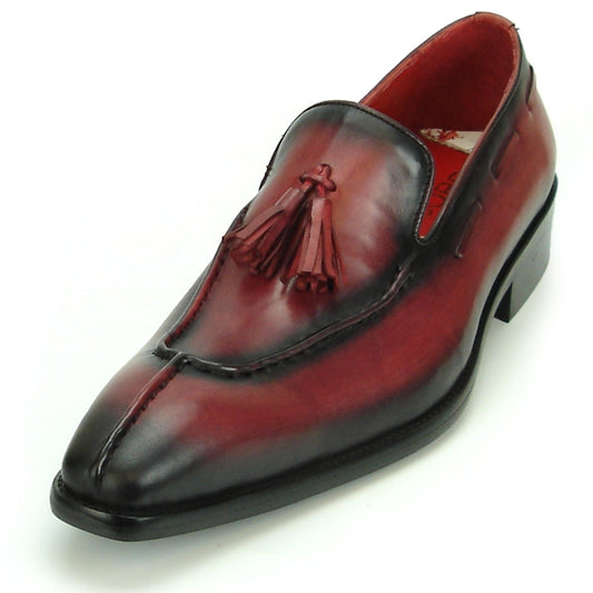 The FI-8701 Burgundy Encore by Fiesso is a polished leather loafer with a maroon hue, black gradient, and tassel detail on the instep that exemplifies high-fashion footwear, set against a plain background.